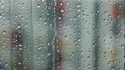 Raindrops Run Down the Window Pane on a Rainy Day