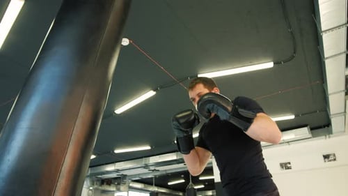 MMA Fighter Boxers Doing Some Training on a Punching Bag at a Gym Close Up Power Punch Kicks Macro