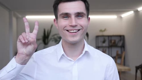 Victory Sign By Positive Businessman