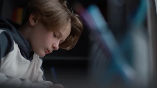 Child Completes Homework at Home Desk