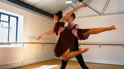 Ballet Dancers Performing a Graceful Lift in Studio