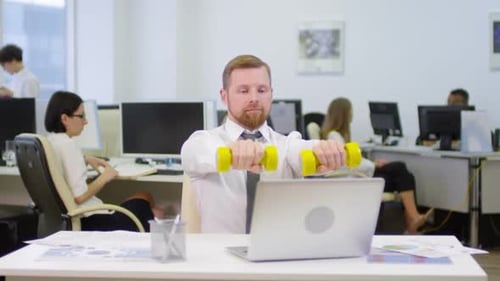 Man Exercising with Dumbbells at Office Desk