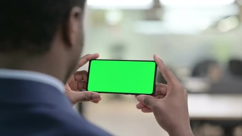 Adult Holds Horizontal Phone with Chroma Key