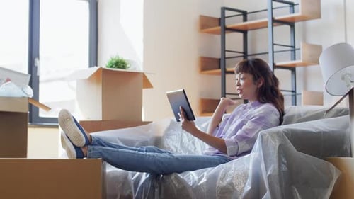 Woman Video Calling on Tablet After Moving In