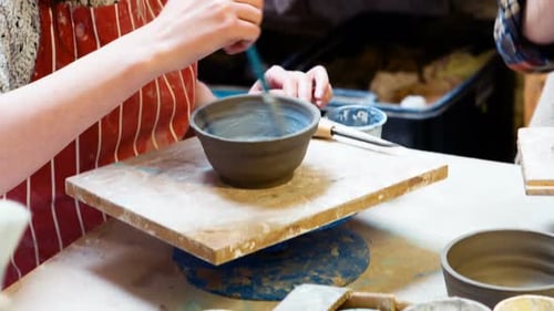Young Woman Painting a Small Pottery Bowl