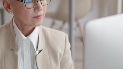 Reife kaukasische Geschäftsfrau arbeitet im Büro am Computer