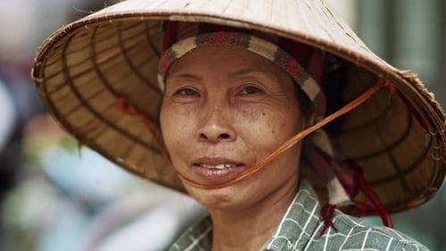 Woman wearing conical hat on city street