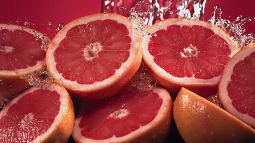 Water Splashing Over Refreshing Grapefruit Halves