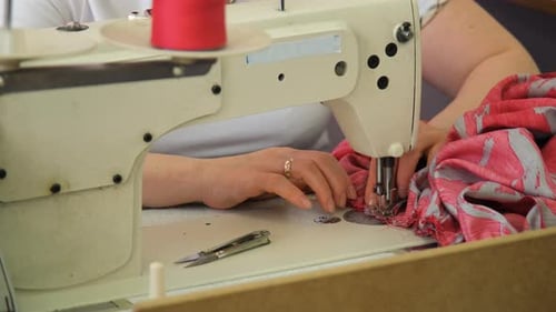 Seamstress Hands Sewing Fabric on Machine
