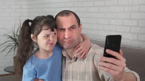 Father and Daughter Posing for Selfie Together