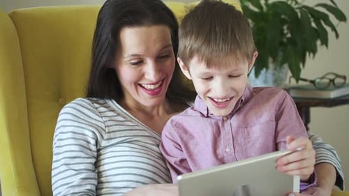 Mother and Child Enjoying Tablet Indoors