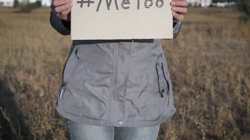 Woman Holds #MeToo Sign in Urban Environment