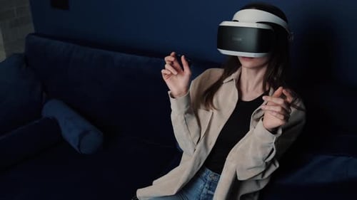 Woman Using Virtual Reality Headset on a Couch