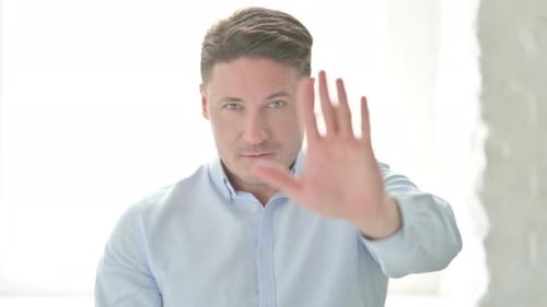 Portrait of Man Showing Stop Sign by Hand
