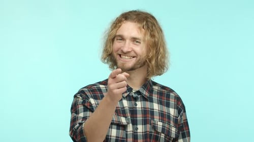 Smiling Man Points at Camera