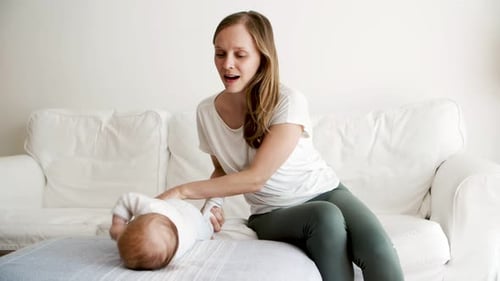 Woman Playing with Adorable Baby on Couch