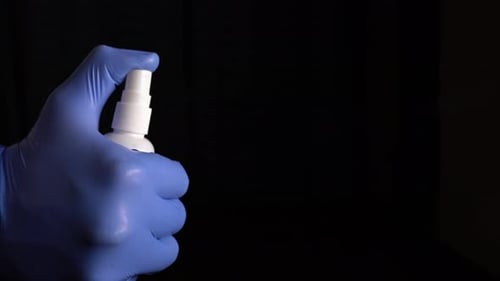 Hand in Glove Sprays Sanitizer Close Up
