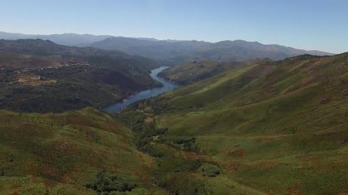 Blue River Winds Through Green Portugal Mountains
