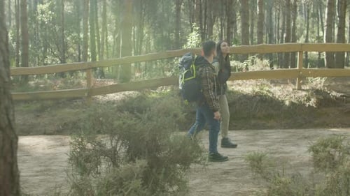 Happy Romantic Couple Walking Along Tourist Trail in Forest