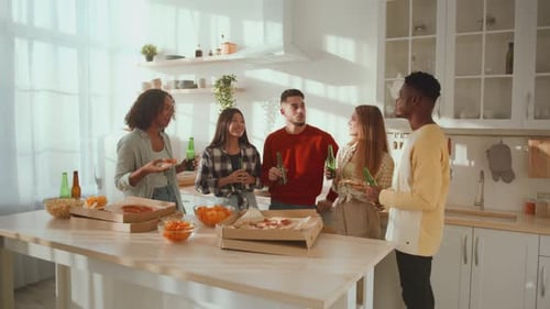 Group of Positive Diverse Friends Enjoying Free Time Talking and Laughing at Kitchen with Beer and