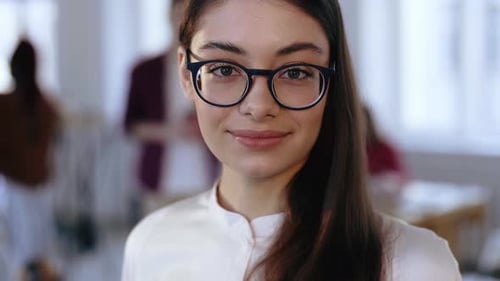 Close-up Portrait, Happy Young Brunette Design Professional Business Woman in Eyeglasses Smiling at