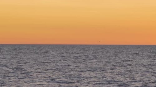 Beautiful view of the calm Baltic sea after the sunset in summer, medium shot from a distance