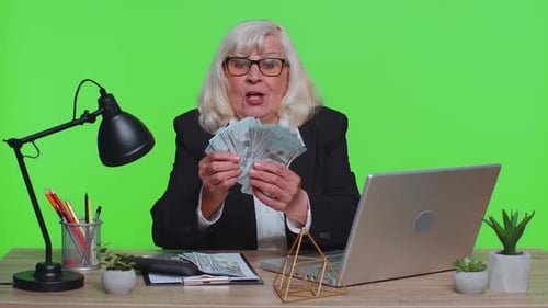 Senior Business Office Woman Analyzes Financial Charts Celebrate Success Win at Home Workplace Desk