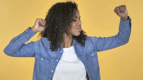 Woman Dancing Happily on Yellow Background