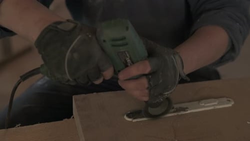 Person Using Power Tool for Grinding