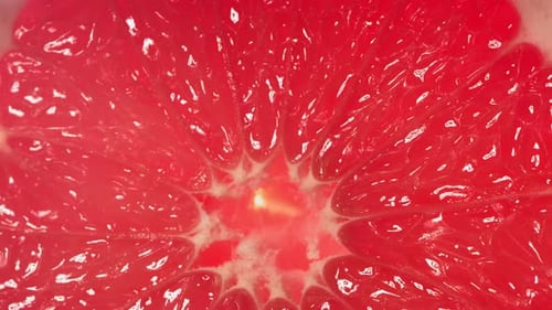 Juicy Red Grapefruit Half Close-Up with Water Droplet