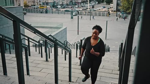 Woman Runs Up Steps in the City