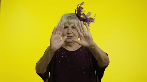 Annoyed Irritated Mature Old Woman Covering Ears and Gesturing No, Avoiding Advice, Ignoring Noise