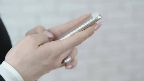 Smartphone in the hands of a girl close-up.