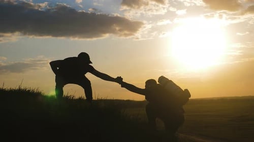 Silhouette of the Team on the Peak of Mountain, Sport and Active Life of People, Teamwork Assistance