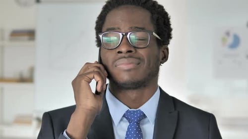 Young Professional Talking on Smartphone at Work