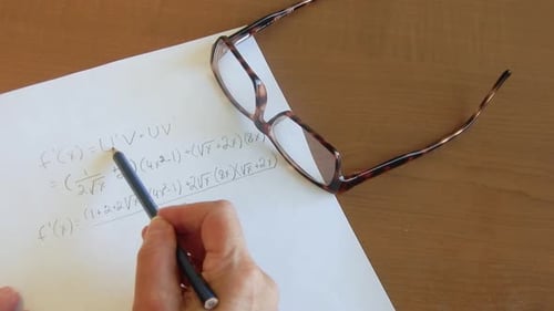 Hand Points to Math Equations on Paper