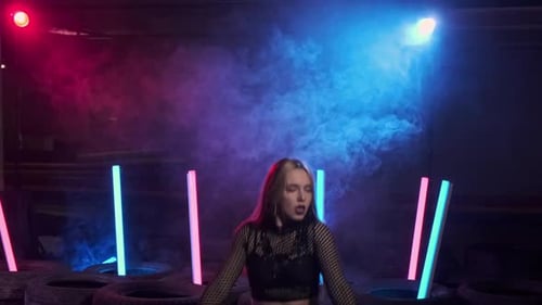 Sexy Woman Enjoying Modern Dance in Smoky Studio with Neon Light