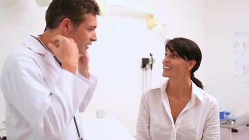 Doctor holding a stethoscope with a patient