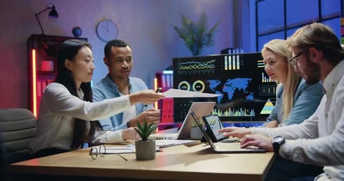 Diverse Team Collaborates on Data Analysis in Modern Office