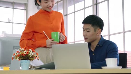 Two Business People Talk Project Strategy at Office