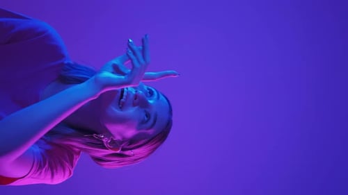 Smiling Young Woman in Pink and Blue Lighting