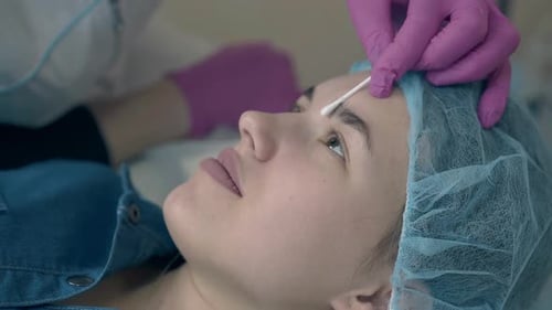 Woman Receives Eyebrow Treatment at Medical Spa