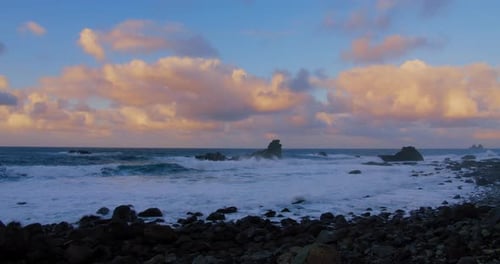 Big Tide Ocean Waves with Foam Splashes Crushing Beach with Volcanic Stones and Rocks Beautiful Warm