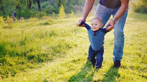 Dad Teaches His Son to Walk