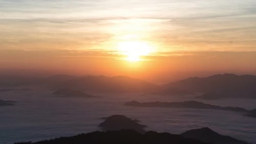 Mountains Covered in Fog during Golden Sunrise