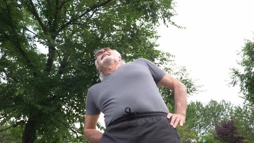 Senior Man Stretching Back in Park