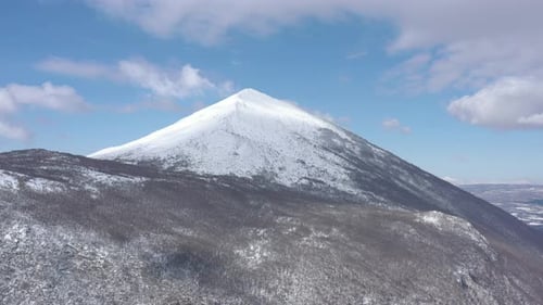 Clouds passing above the snowed Rtanj mountain 4K drone video