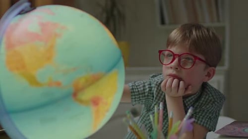 Young Boy Learns About Geography From Globe