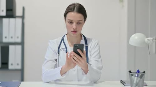Female Doctor Using Smartphone in Modern Office