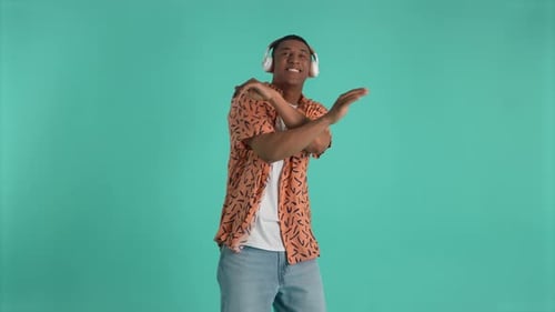 Man Dancing to Music with Headphones on Green Screen